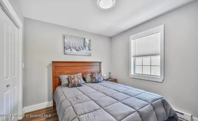 a bedroom with a bed a couch and a window