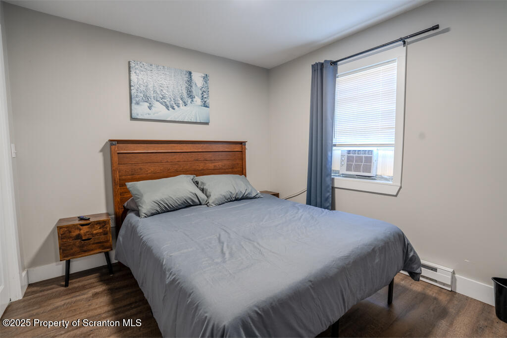 4562 Highway 374 Nicholson, PA 18446 - Photo 32 of 38 a bedroom with a bed a couch and a window