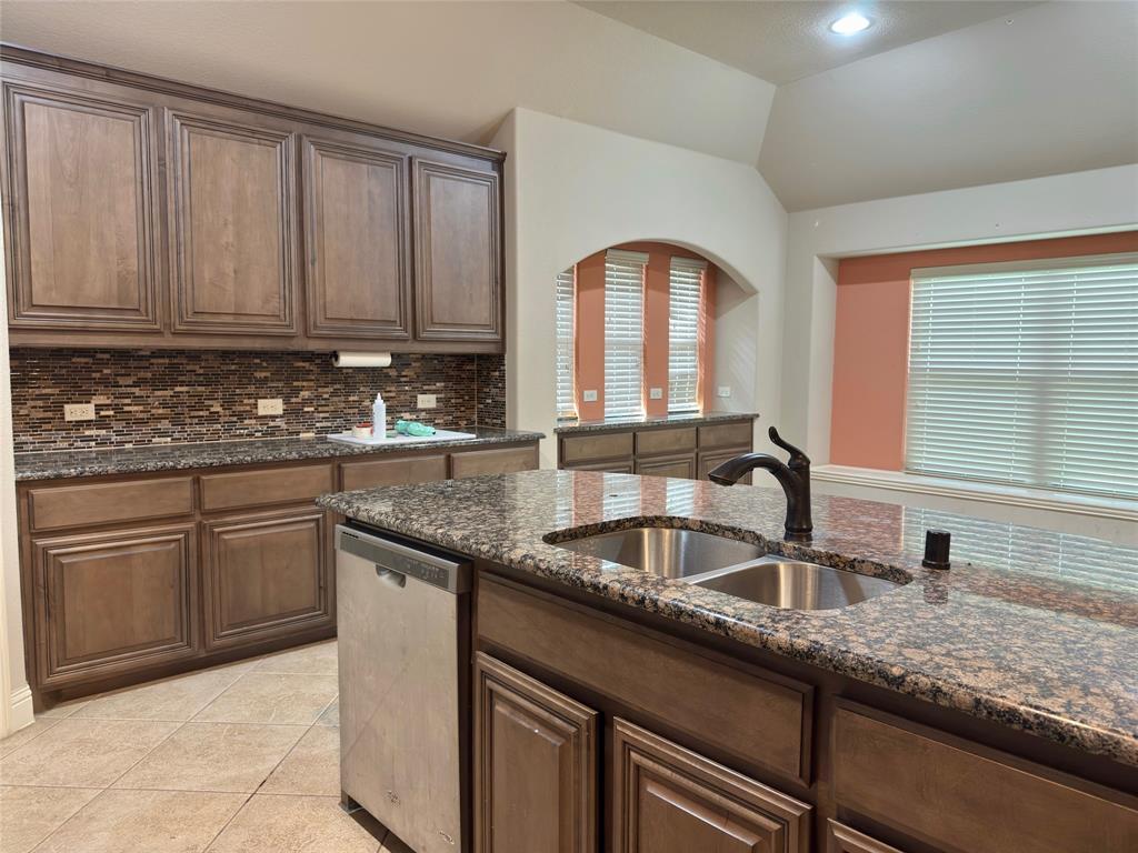 1017 Knoxbridge Road Forney, TX 75126 - Photo 12 of 16 a kitchen with granite countertop a sink and cabinets