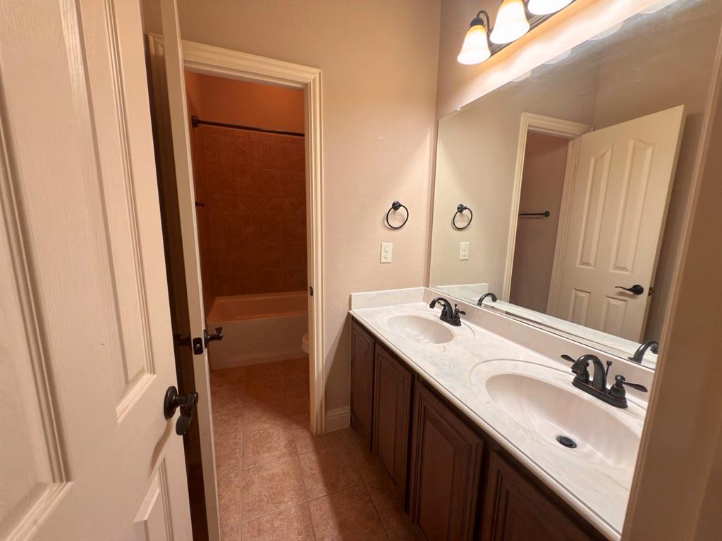 1017 Knoxbridge Road Forney, TX 75126 - Photo 4 of 16 a bathroom with a double vanity sink a and mirror