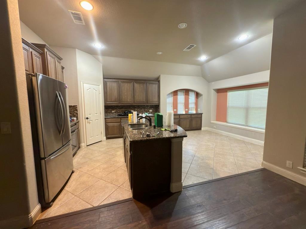 1017 Knoxbridge Road Forney, TX 75126 - Photo 8 of 16 a view of kitchen with refrigerator stove and wooden floor