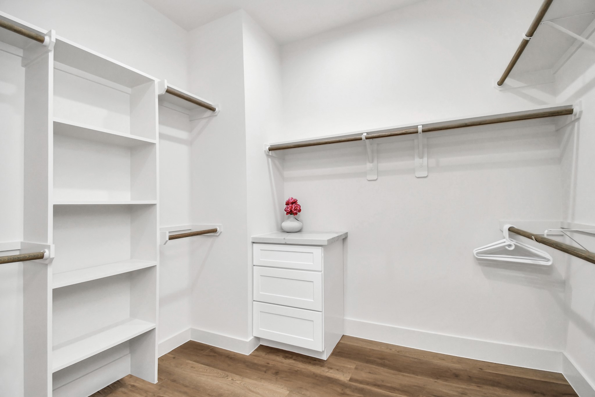 2512 Gray Street Houston, TX 77003 - Photo 28 of 46 Spacious walk-in closet with white shelving, ample hanging space, and a small dresser. Bright and organized, perfect for storage.