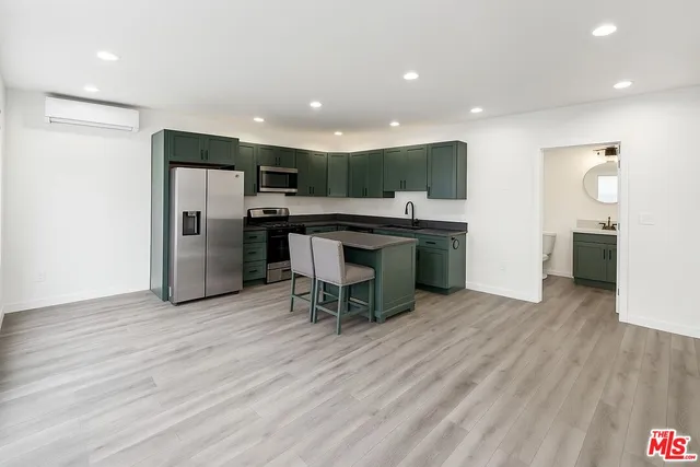 a view of a kitchen with a sink and a refrigerator