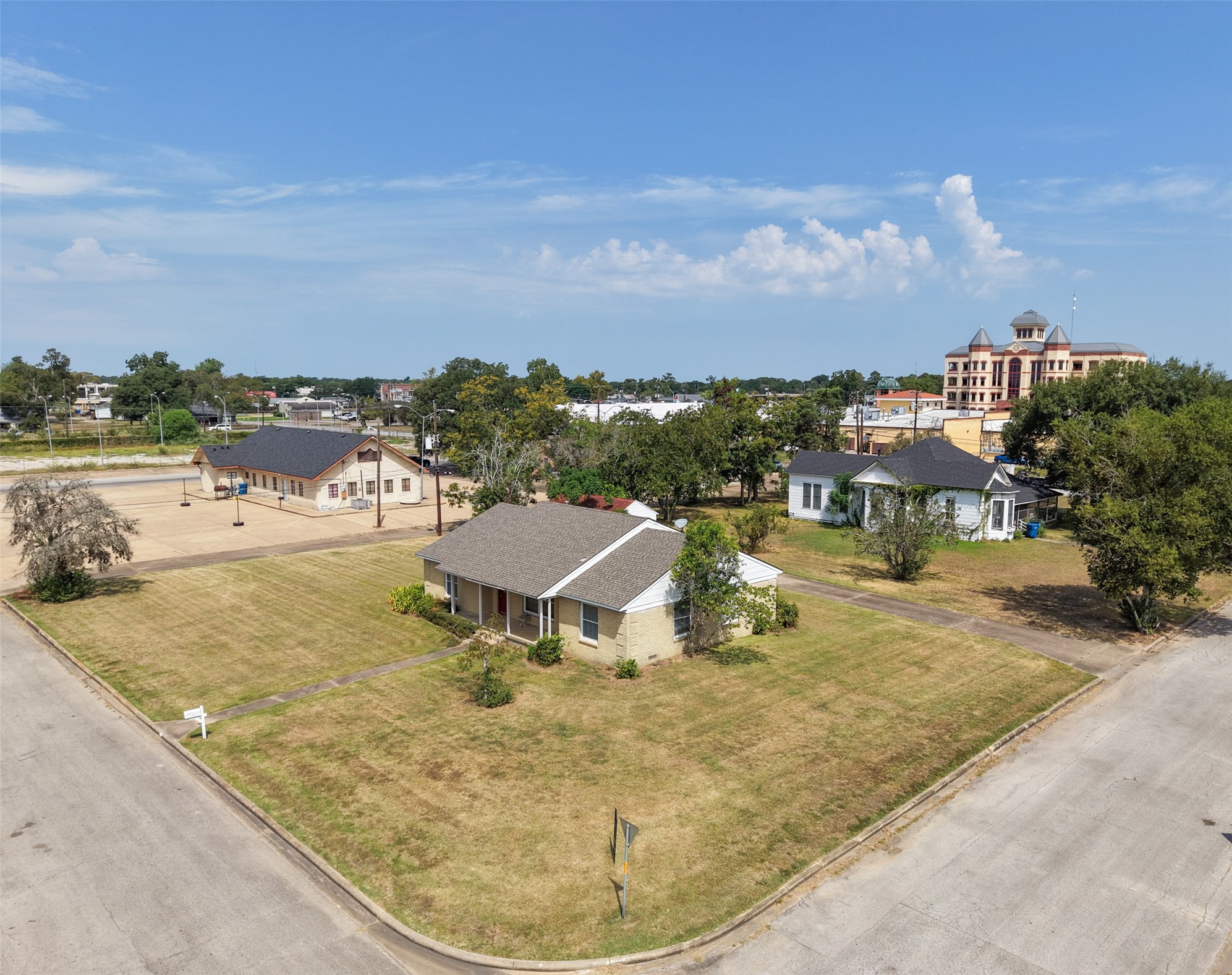 810 Main Street Hempstead, TX 77445 - Photo 3 of 32 Aerial view showcasing the property’s corner location with expansive road frontage and easy access from Main Street.