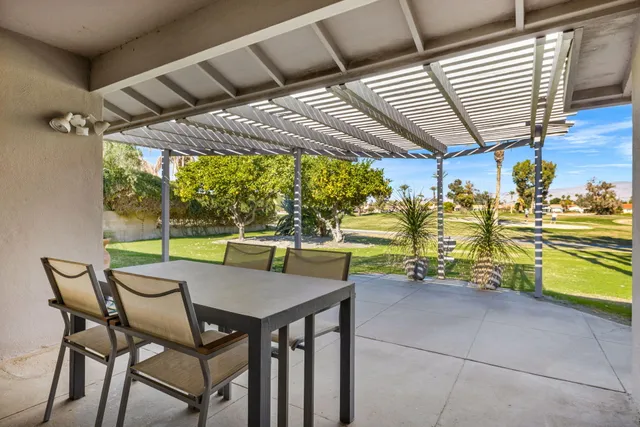 a view of a patio with a table and chairs