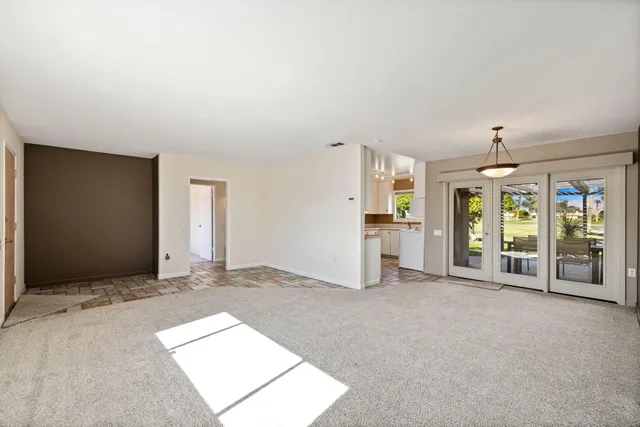 a view of an empty room with large windows