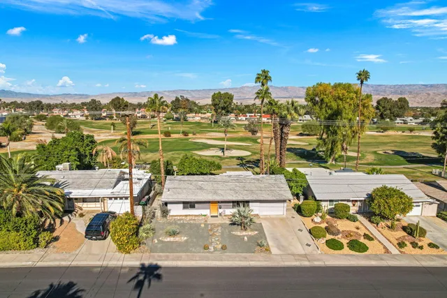 an aerial view of residential houses with outdoor space