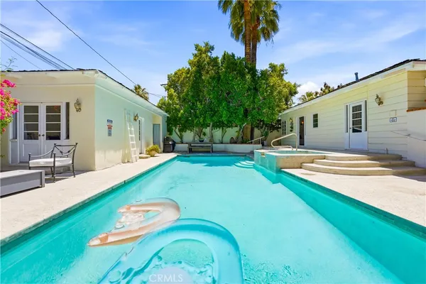 a view of a swimming pool with an outdoor space and seating area