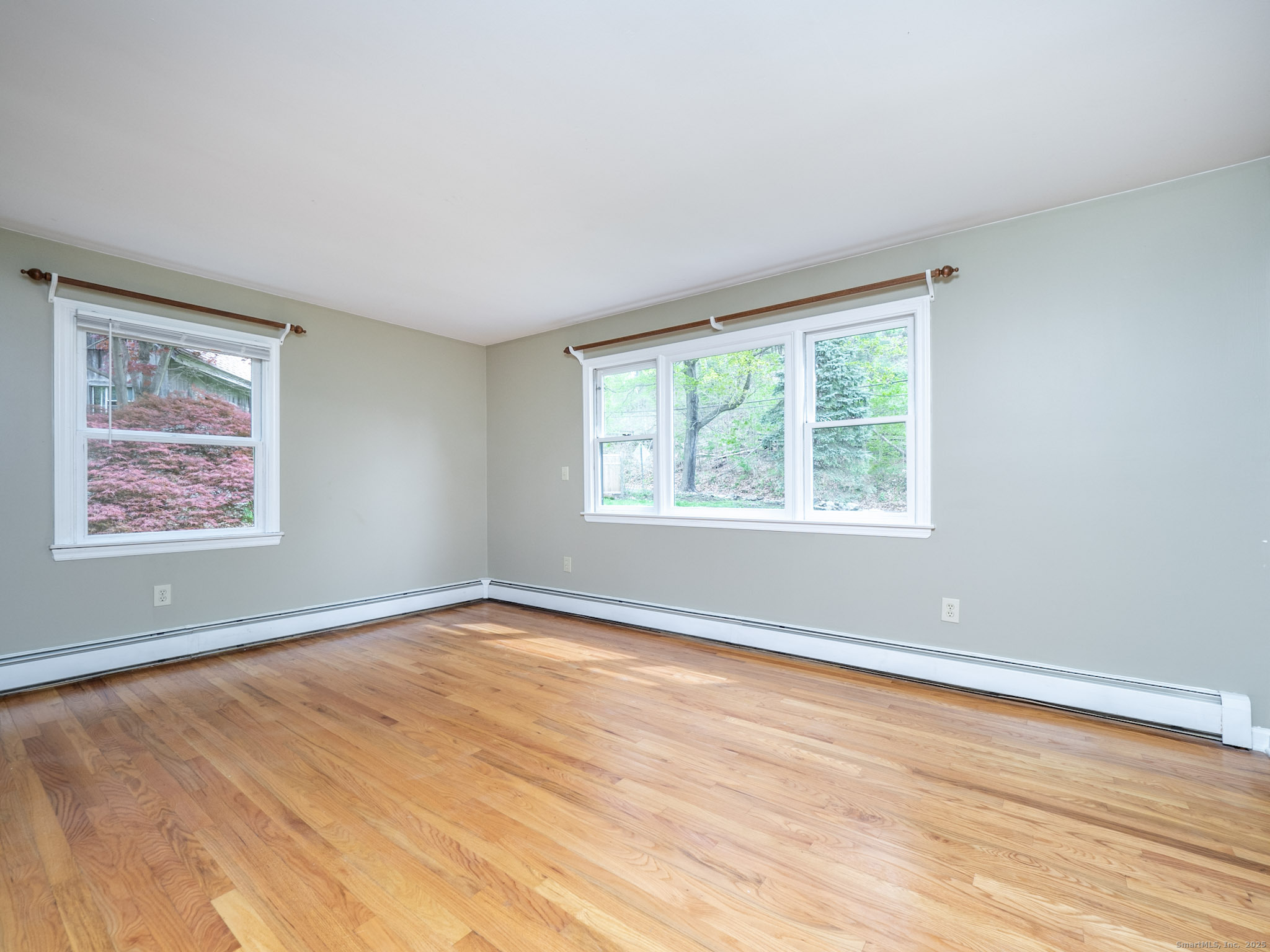 21 Simpaug Turnpike Redding, CT 06896 - Photo 11 of 22 a view of an empty room with wooden floor and a window