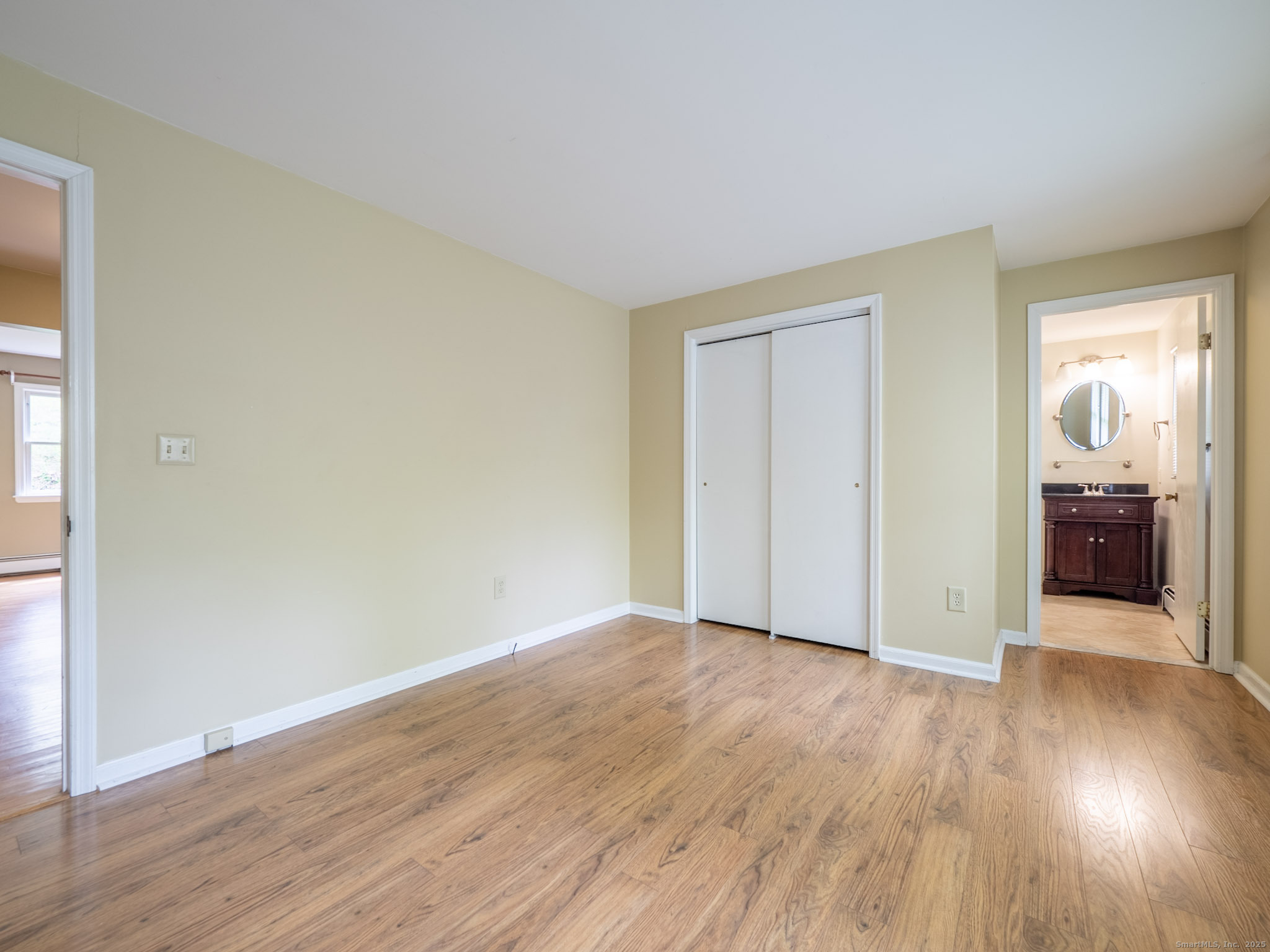 21 Simpaug Turnpike Redding, CT 06896 - Photo 12 of 22 an empty room with wooden floor and windows