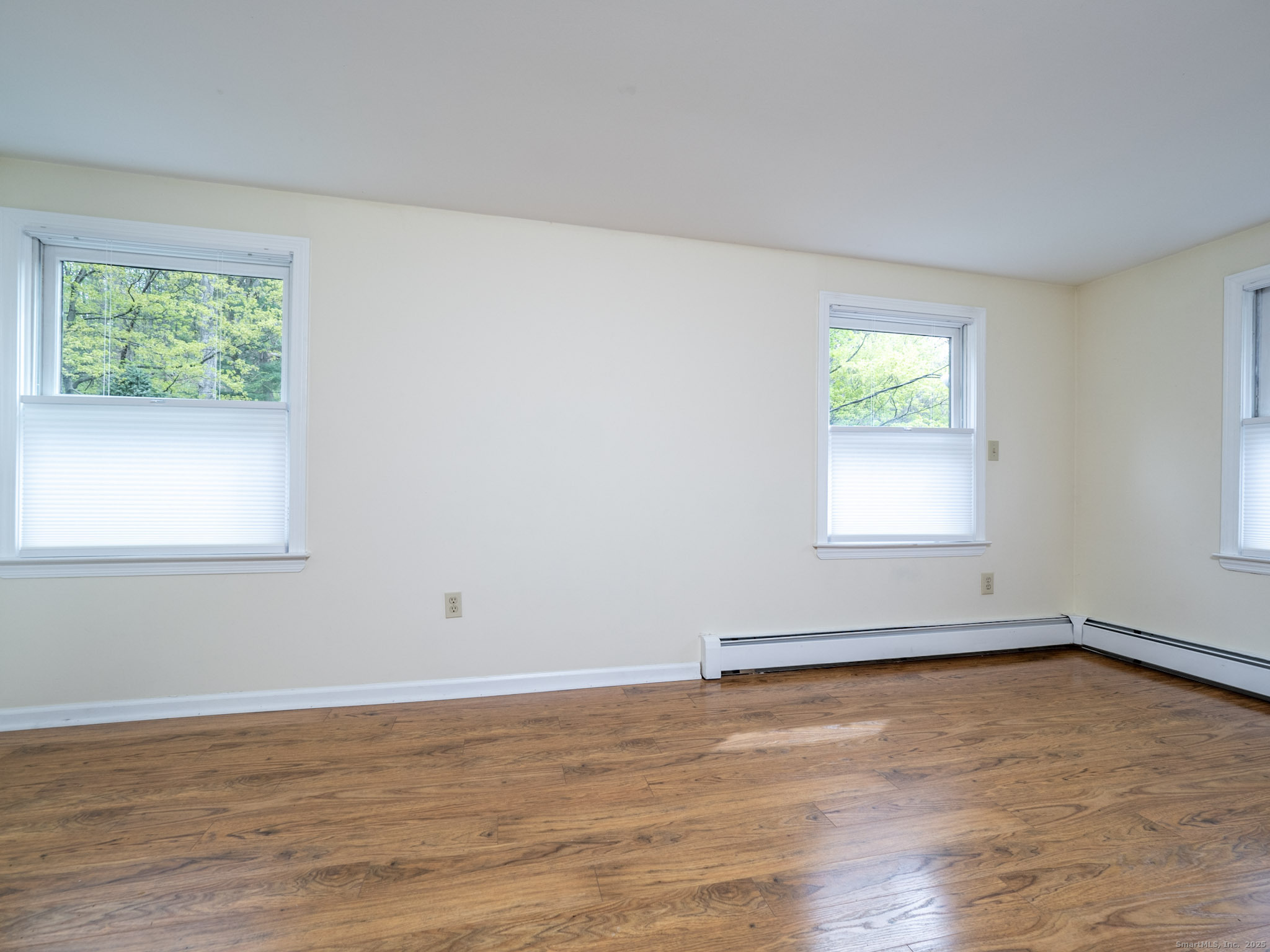 21 Simpaug Turnpike Redding, CT 06896 - Photo 13 of 22 a view of an empty room with wooden floor and a window