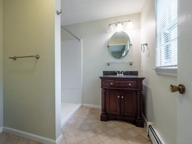 a room with a mirror and vanity