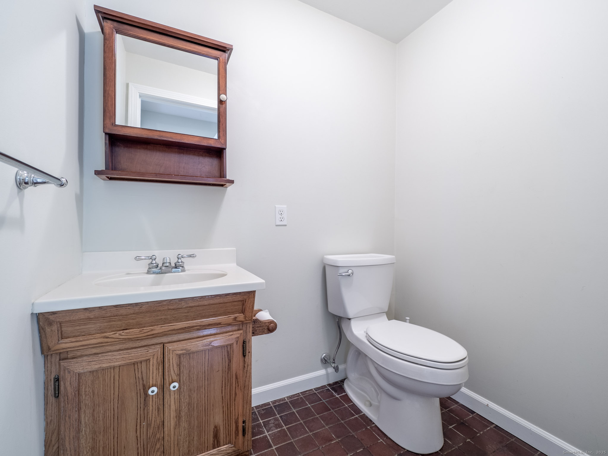 21 Simpaug Turnpike Redding, CT 06896 - Photo 18 of 22 a bathroom with a toilet a sink and mirror