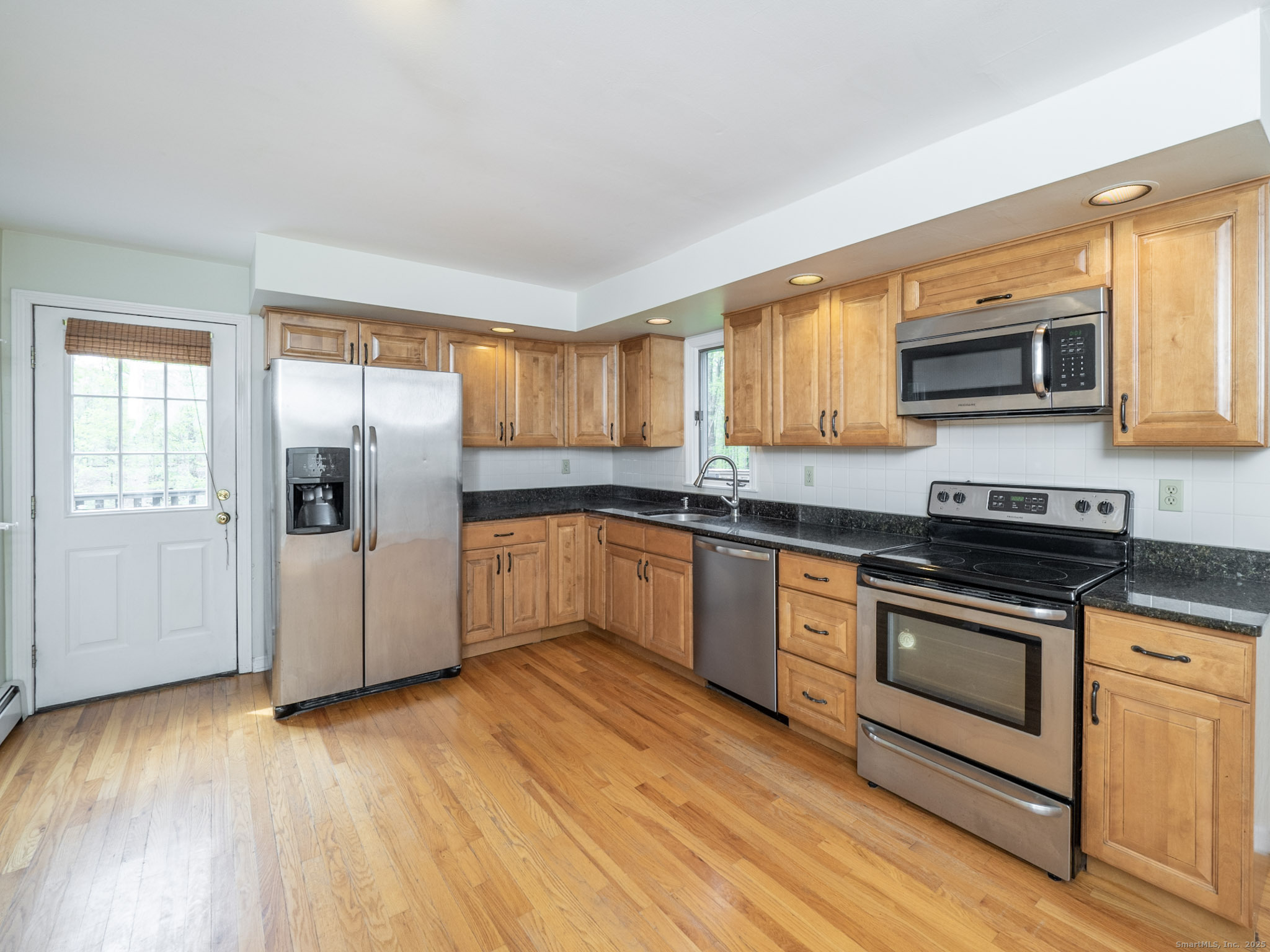 21 Simpaug Turnpike Redding, CT 06896 - Photo 6 of 22 a kitchen with stainless steel appliances granite countertop a stove a sink and a microwave