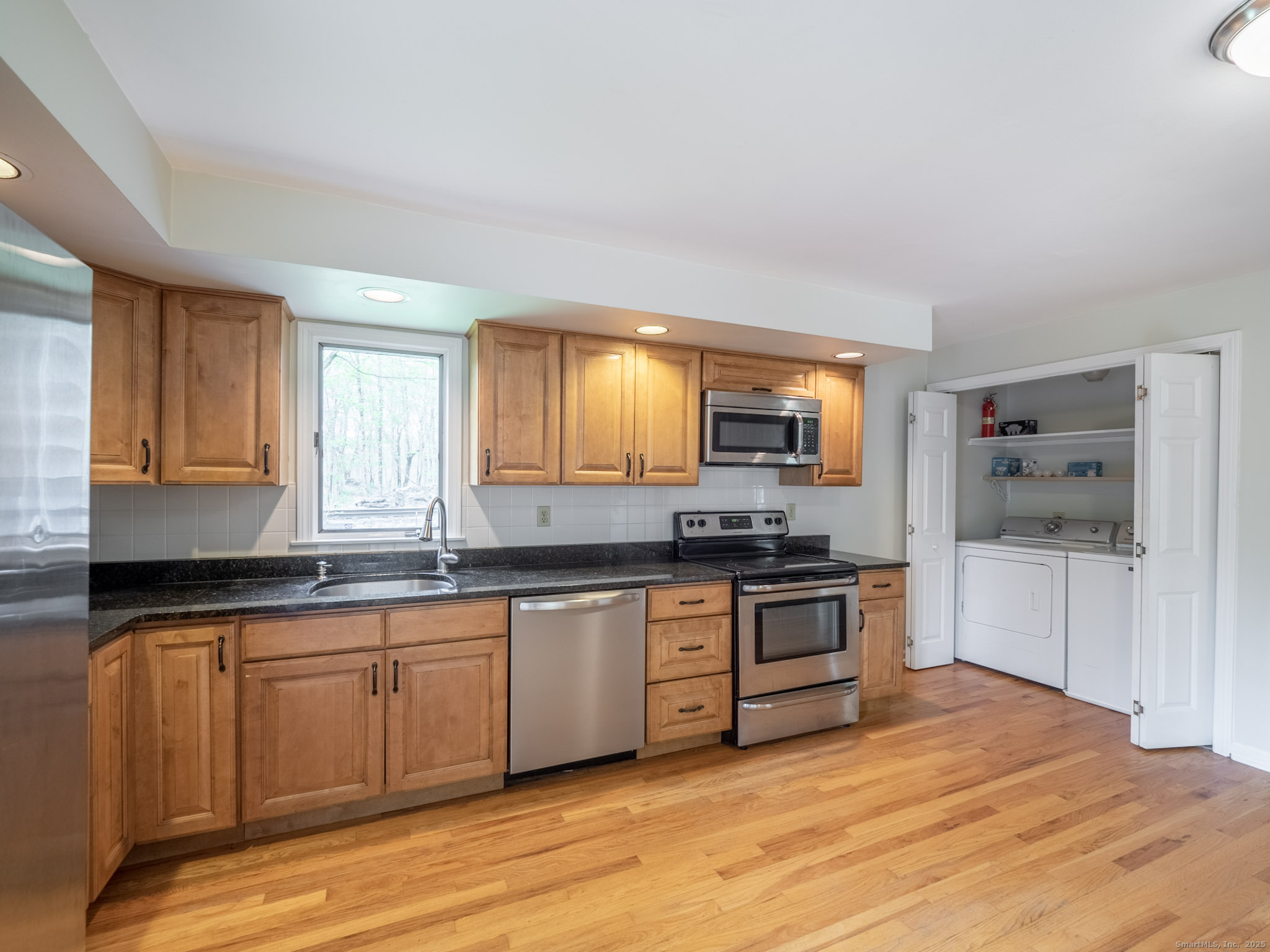 21 Simpaug Turnpike Redding, CT 06896 - Photo 7 of 22 a kitchen with stainless steel appliances granite countertop a stove a sink and a microwave