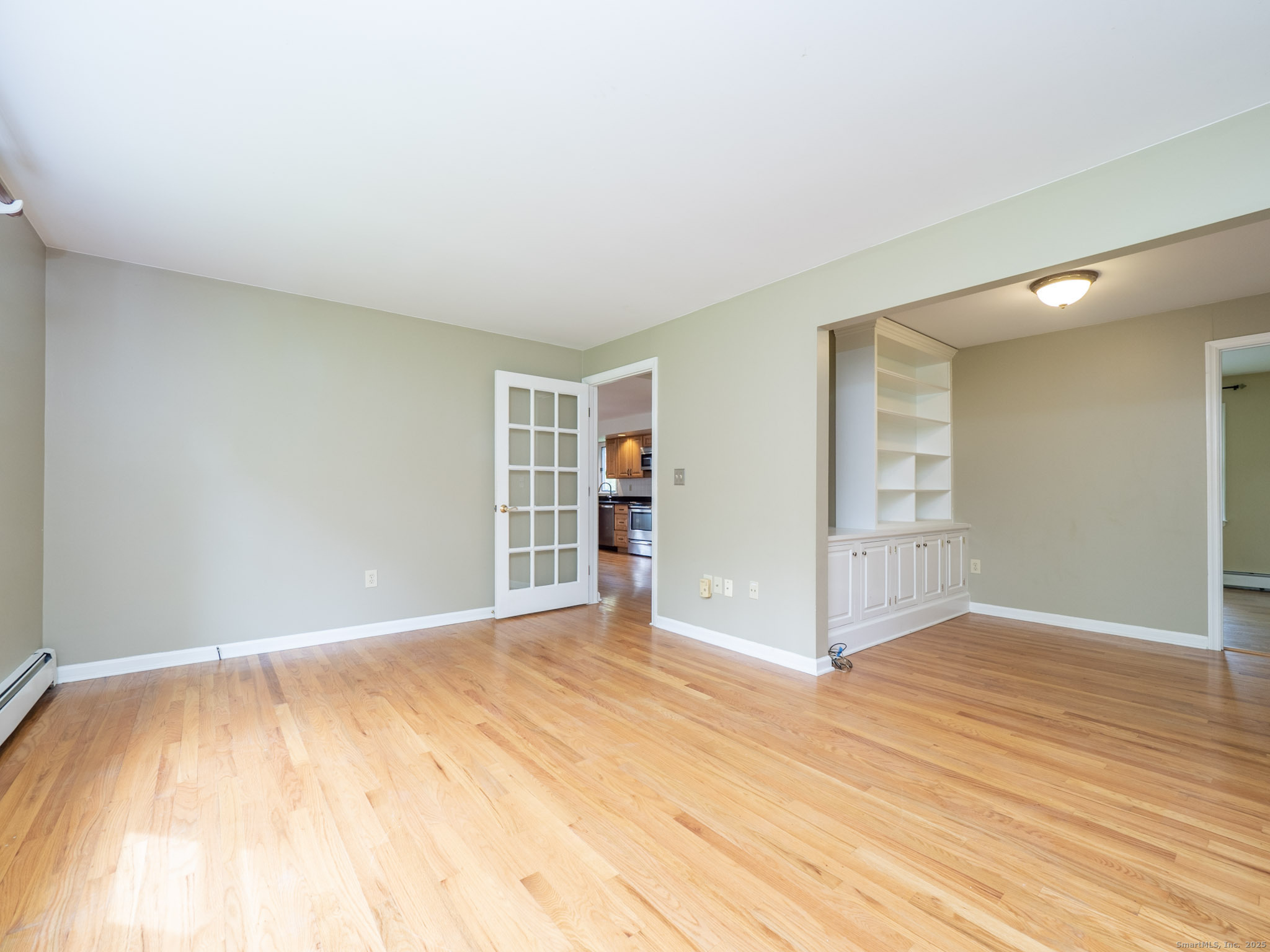 21 Simpaug Turnpike Redding, CT 06896 - Photo 9 of 22 a view of an empty room with wooden floor and a window