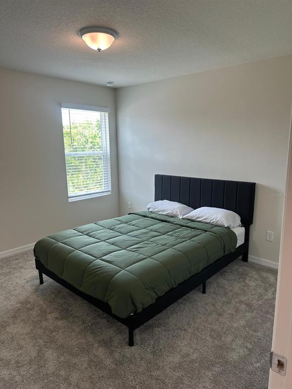 4669 Sparkling Shell Avenue Kissimmee, FL 34746 - Photo 12 of 21 a bedroom with a bed and a window