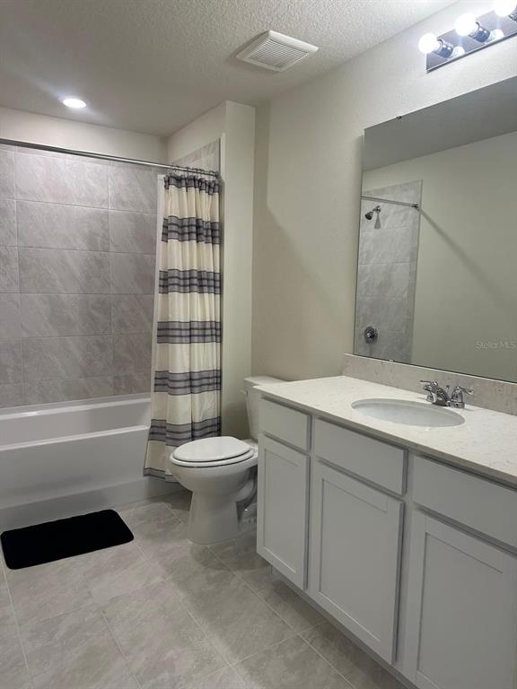 4669 Sparkling Shell Avenue Kissimmee, FL 34746 - Photo 13 of 21 a bathroom with a sink a toilet and shower