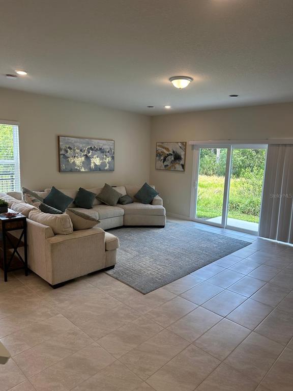 4669 Sparkling Shell Avenue Kissimmee, FL 34746 - Photo 6 of 21 a living room with furniture and a large window