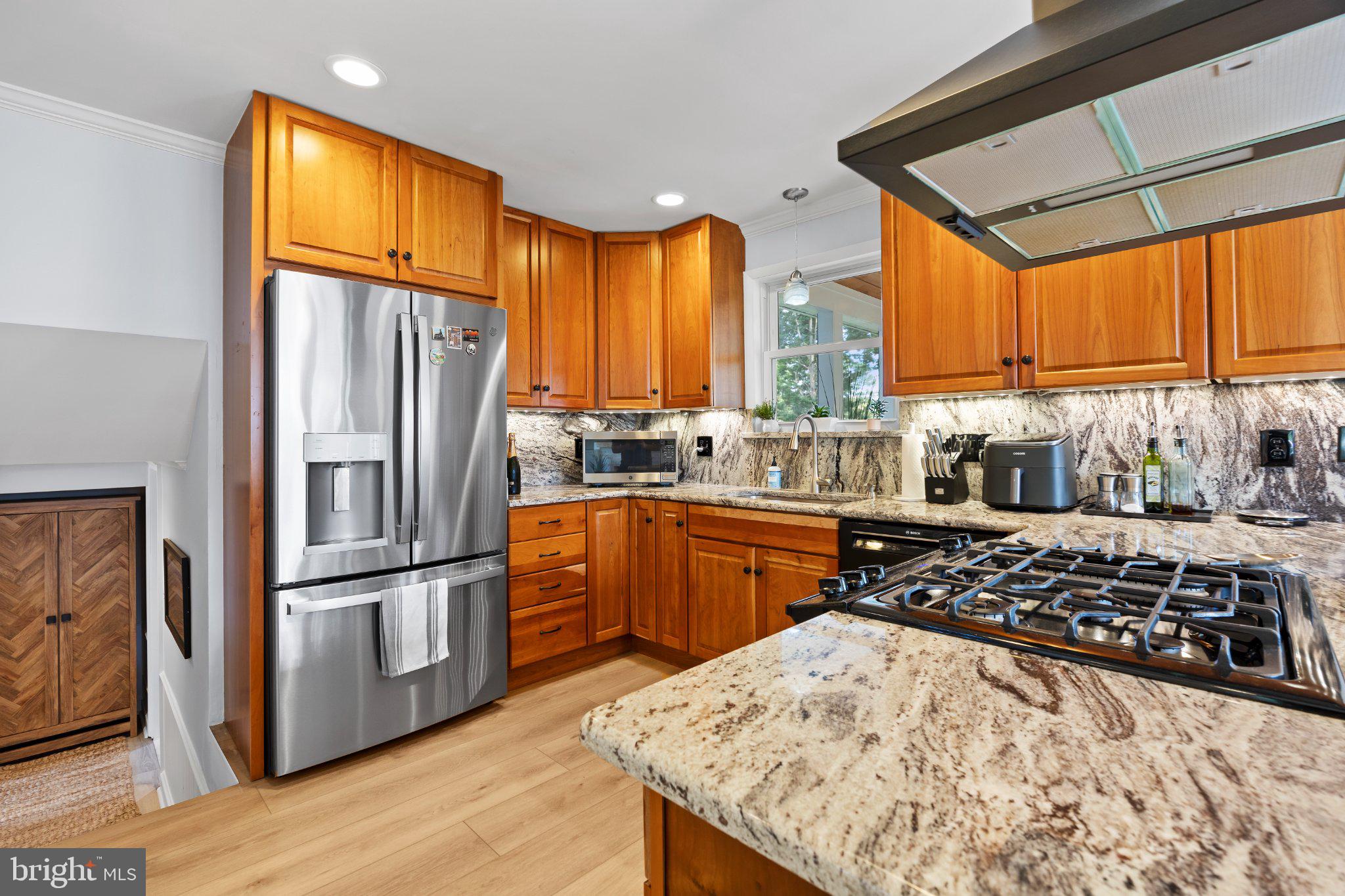 6705 New Hope Drive Springfield, VA 22151 - Photo 23 of 67 Modern kitchen with warm wood tones.