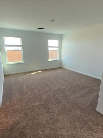 a view of a livingroom with furniture and a ceiling fan