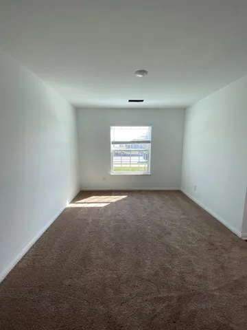 an empty room with a empty space and windows