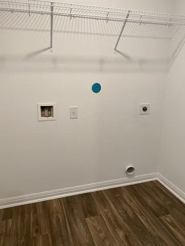 a view of a room with wooden floor