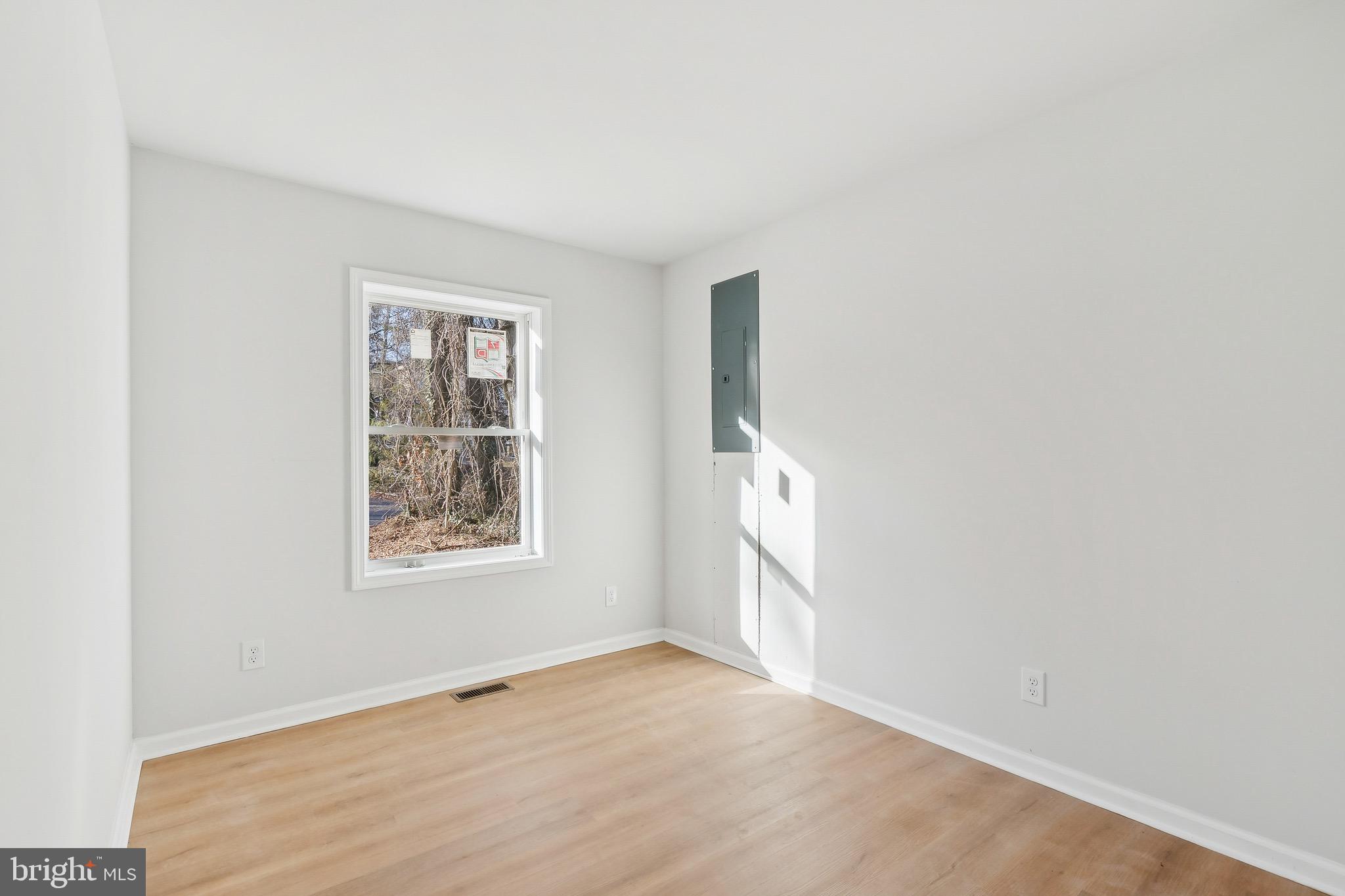 47 Highland Avenue Clementon, NJ 08021 - Photo 15 of 19 an empty room with wooden floor and windows