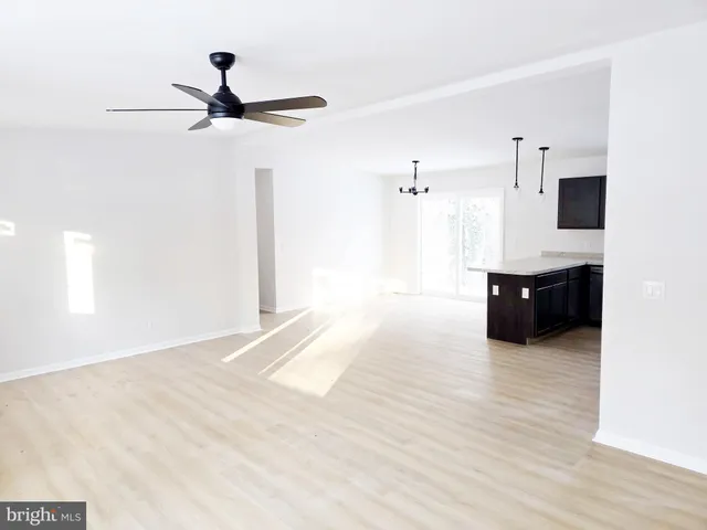 a living room with a ceiling fan and a ceiling fan