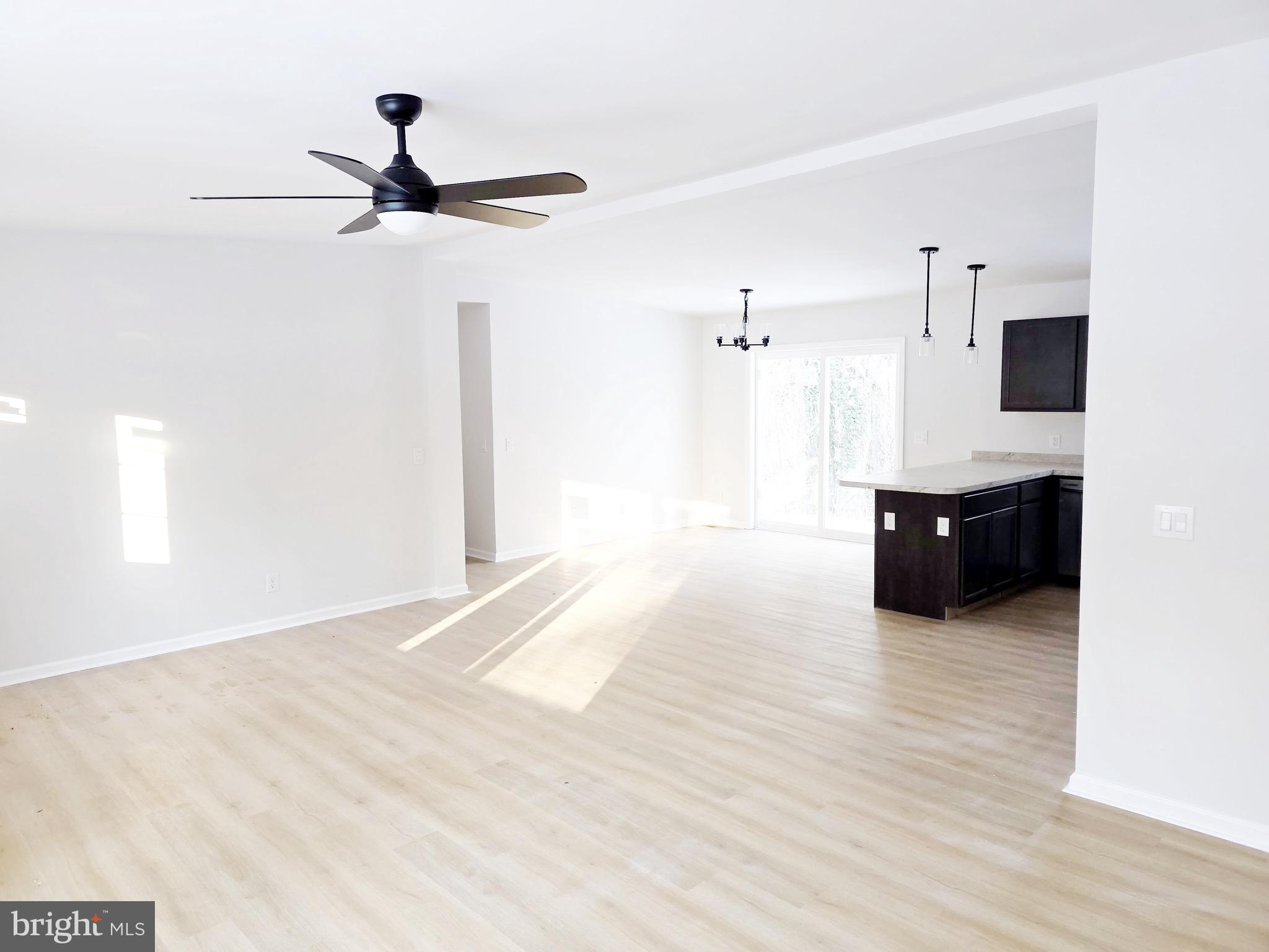 47 Highland Avenue Clementon, NJ 08021 - Photo 3 of 19 a living room with a ceiling fan and a ceiling fan