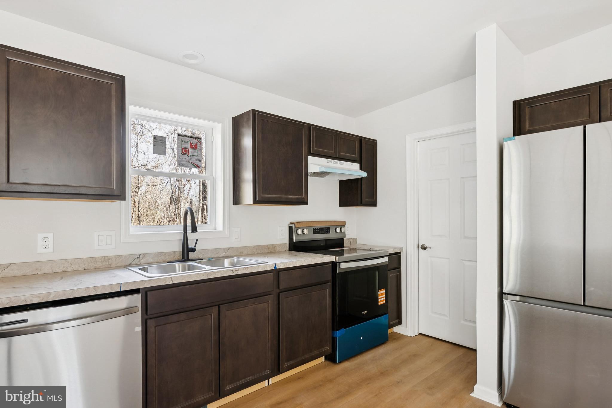 47 Highland Avenue Clementon, NJ 08021 - Photo 7 of 19 a kitchen with stainless steel appliances granite countertop a refrigerator and a sink