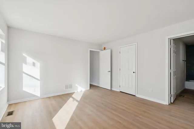 a view of room with window and wooden floor