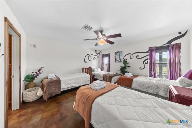 a bedroom with two beds and a chandelier