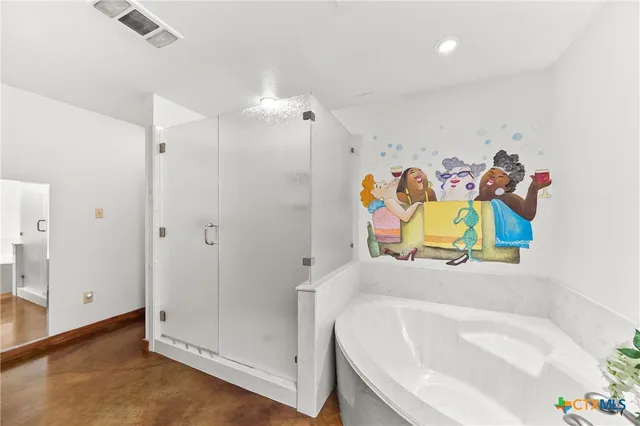 a bathroom with a tub sink and vanity