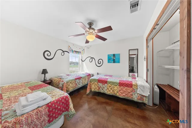 a bedroom with two beds and a chandelier