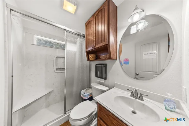 a bathroom with a toilet a sink and a mirror