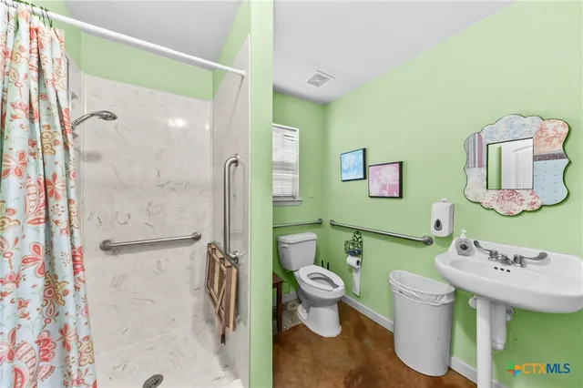 a bathroom with a sink toilet and shower