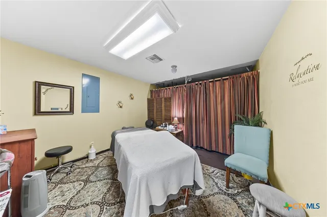 a room with furniture a rug and a window