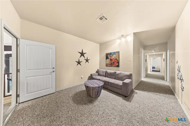 a living room with furniture and a rug