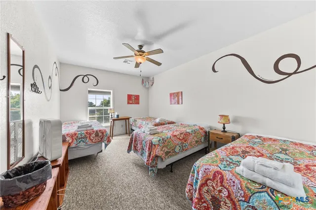 a bedroom with two beds and a window