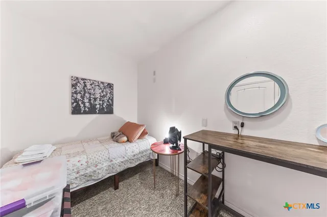 a bedroom with a bed and a table