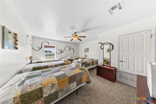 a bedroom with bed and a chandelier