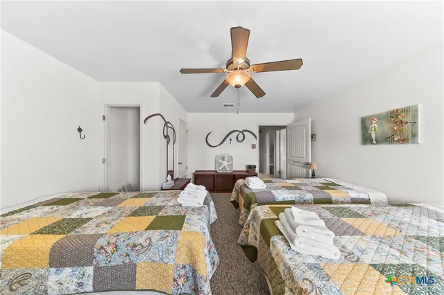 a bedroom with double bed and a painting on the wall