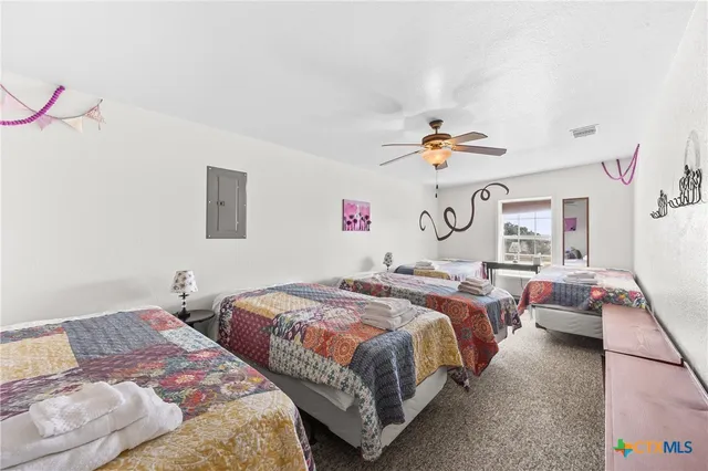 a bedroom with two beds and a chandelier