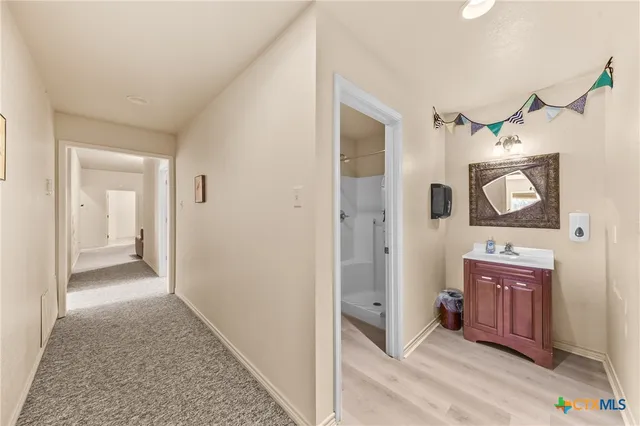 a bedroom with two beds and a chandelier