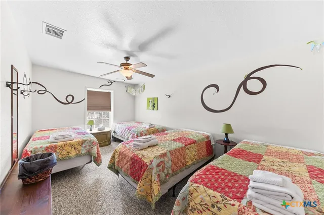 a bedroom with two beds and a chandelier