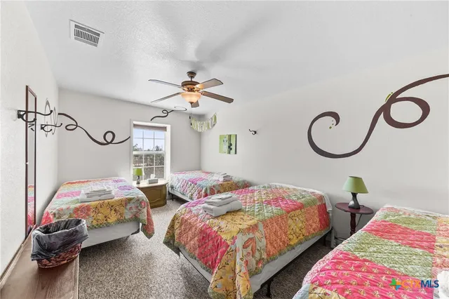 a bedroom with a bed and lamp