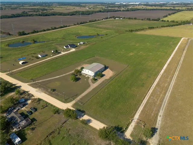a view of a field with an ocean view
