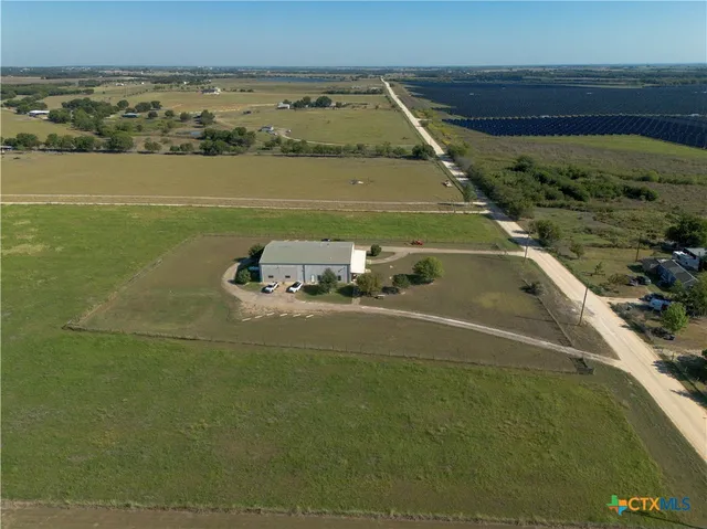 an aerial view of a house with a yard