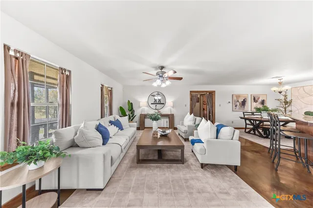 a living room with furniture and a large window